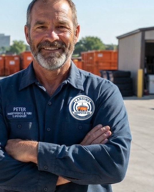 Paul, Lansing Dumpster Co operations director, with company trucks